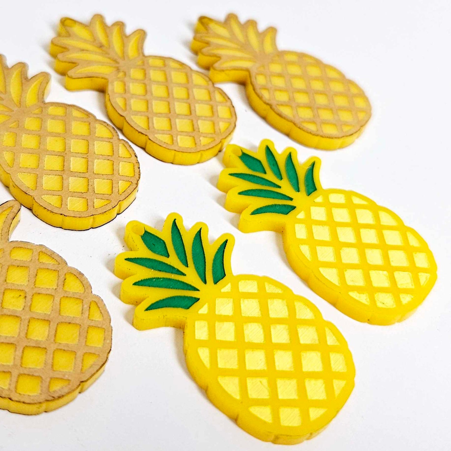 yellow acrylic pineapple earring blanks that have been paint filled with sunshine yellow and green posca paint pens