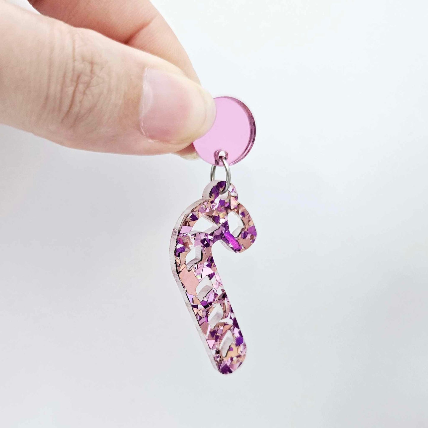 pink mirror earring toppers paired with Christmas candy cane dangles for festive earrings