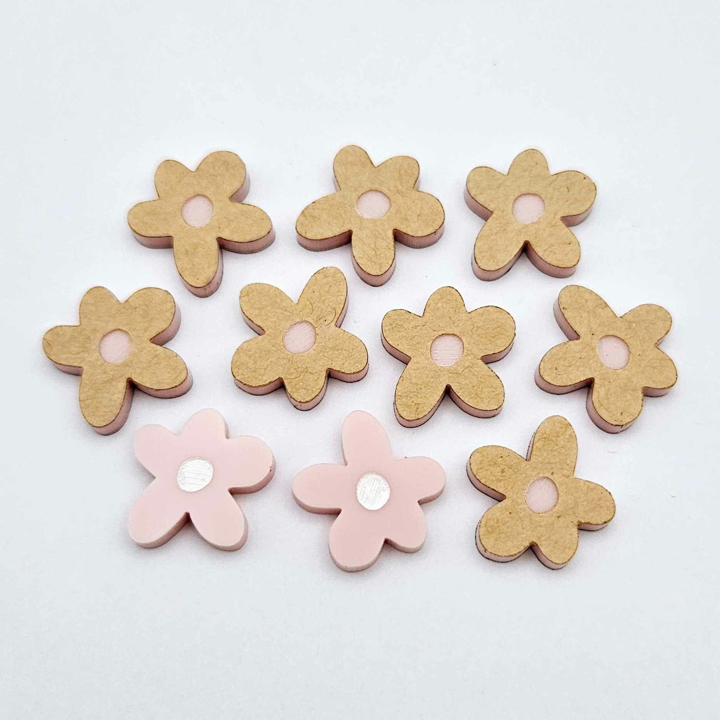 16mm dusty pale pink organic flower stud blanks with engraved centre, one pair paint filled white and several unfilled pieces shown with protective film on