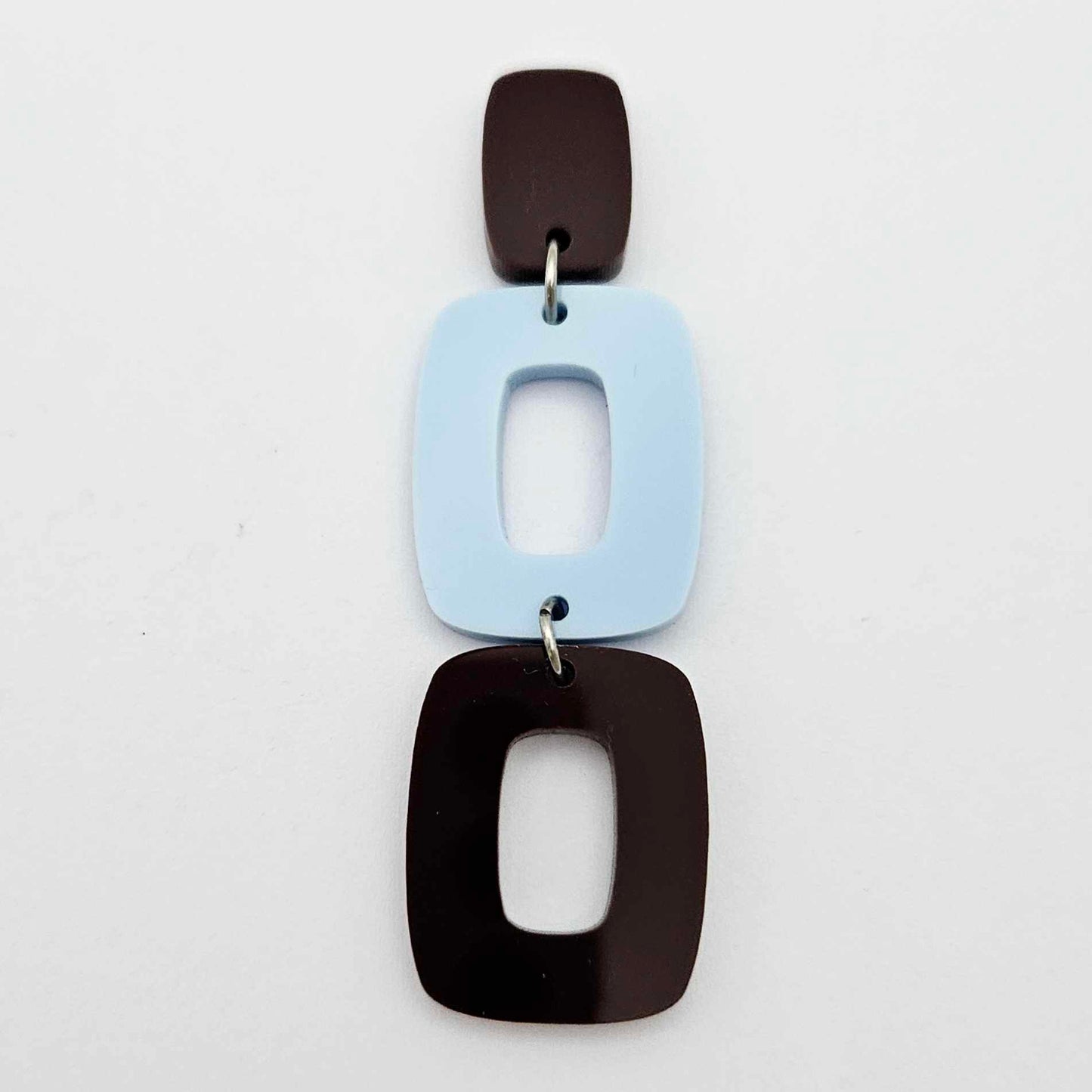 Assembled layered rectangle dangle earring in chocolate brown and pastel blue acrylic, three-piece geometric statement design