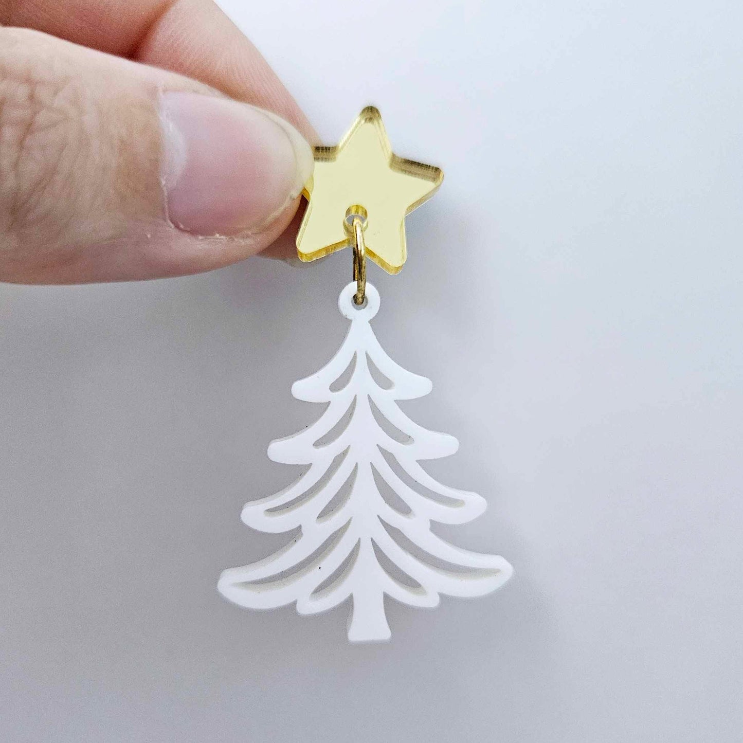 One 35mm white acrylic Cascade Christmas Tree dangle blank assembled with a 16mm star topper, shown as a finished earring component