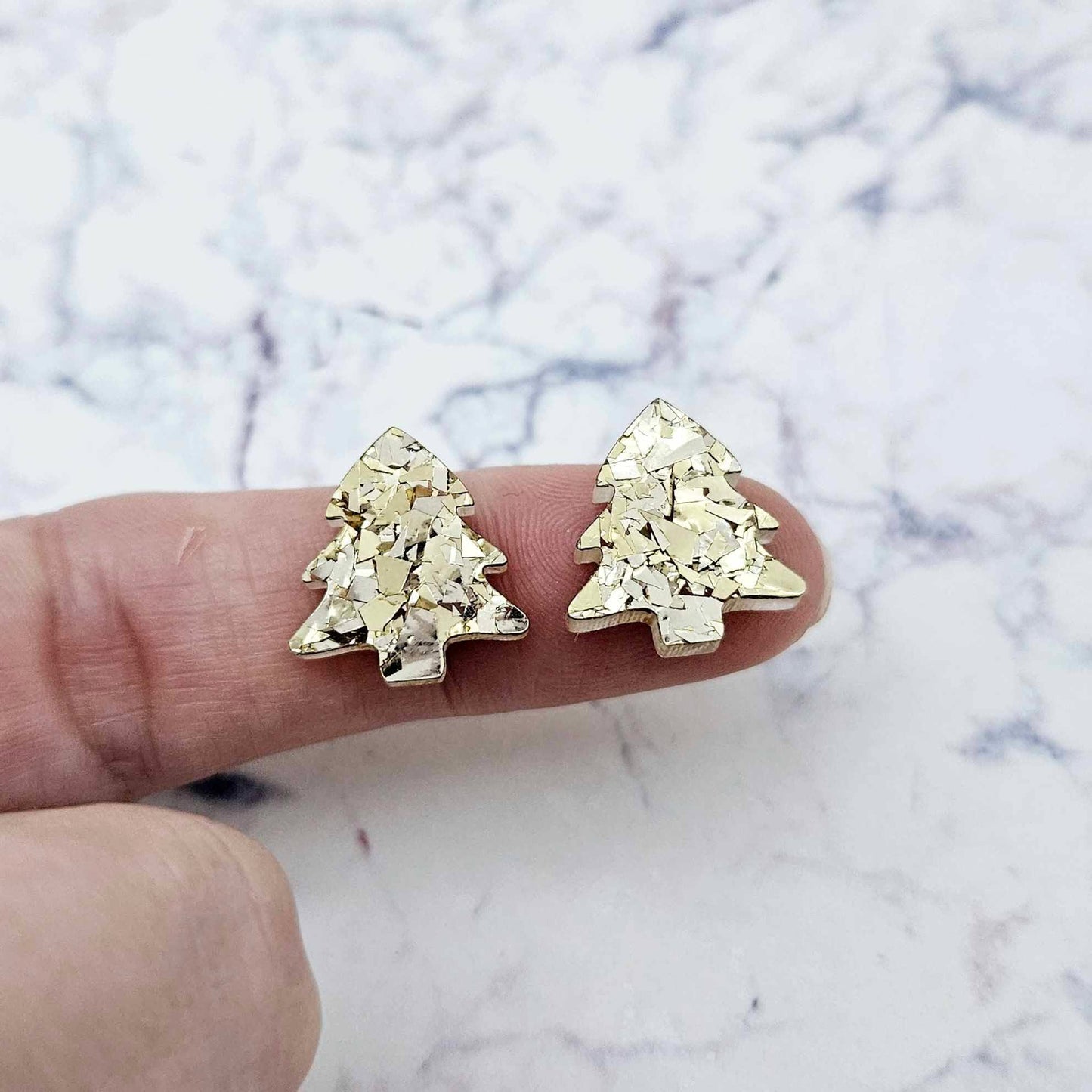 One pair of each 16mm chunky gold glitter acrylic Christmas tree stud earring blanks – shown on a finger for size reference.