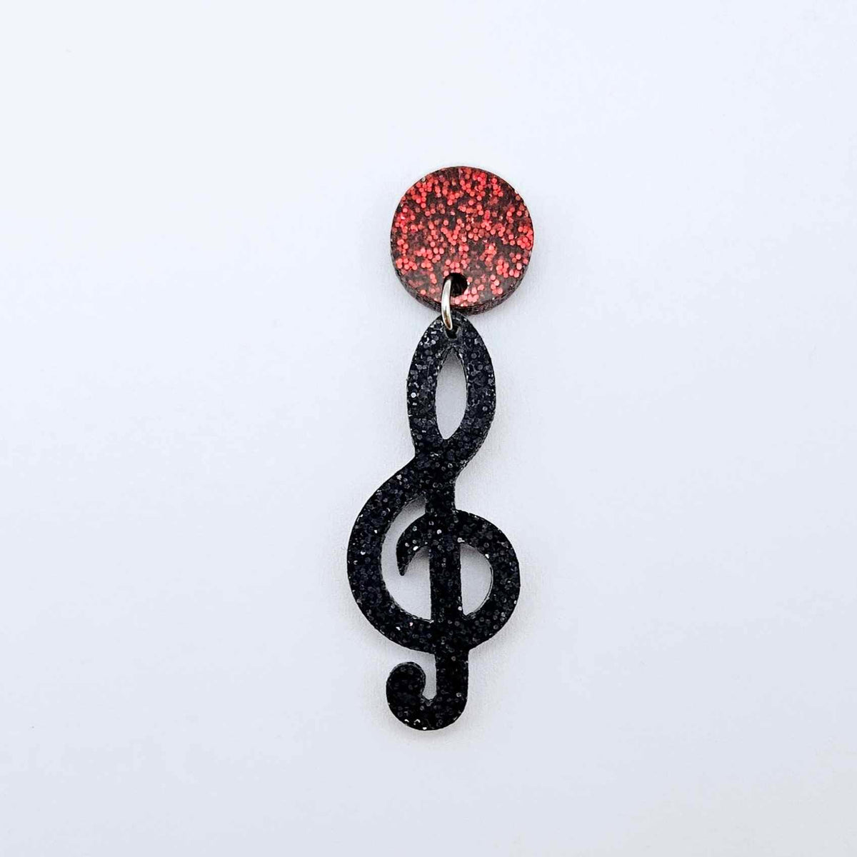 40mm holographic black glitter treble clef earring dangle blank assembled with a 14mm red glitter topper, showing how the pieces can be paired to create a finished music inspired earring.