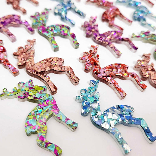 A selection of 45mm chunky glitter acrylic reindeer dangle earring blanks in Holographic Rose Gold, Chunky Love, Aqua, Peacock and Unicorn Glitter laying flat.