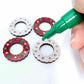 red glitter acrylic wreath earring blanks that are being paint filled with green and white posca paint pens