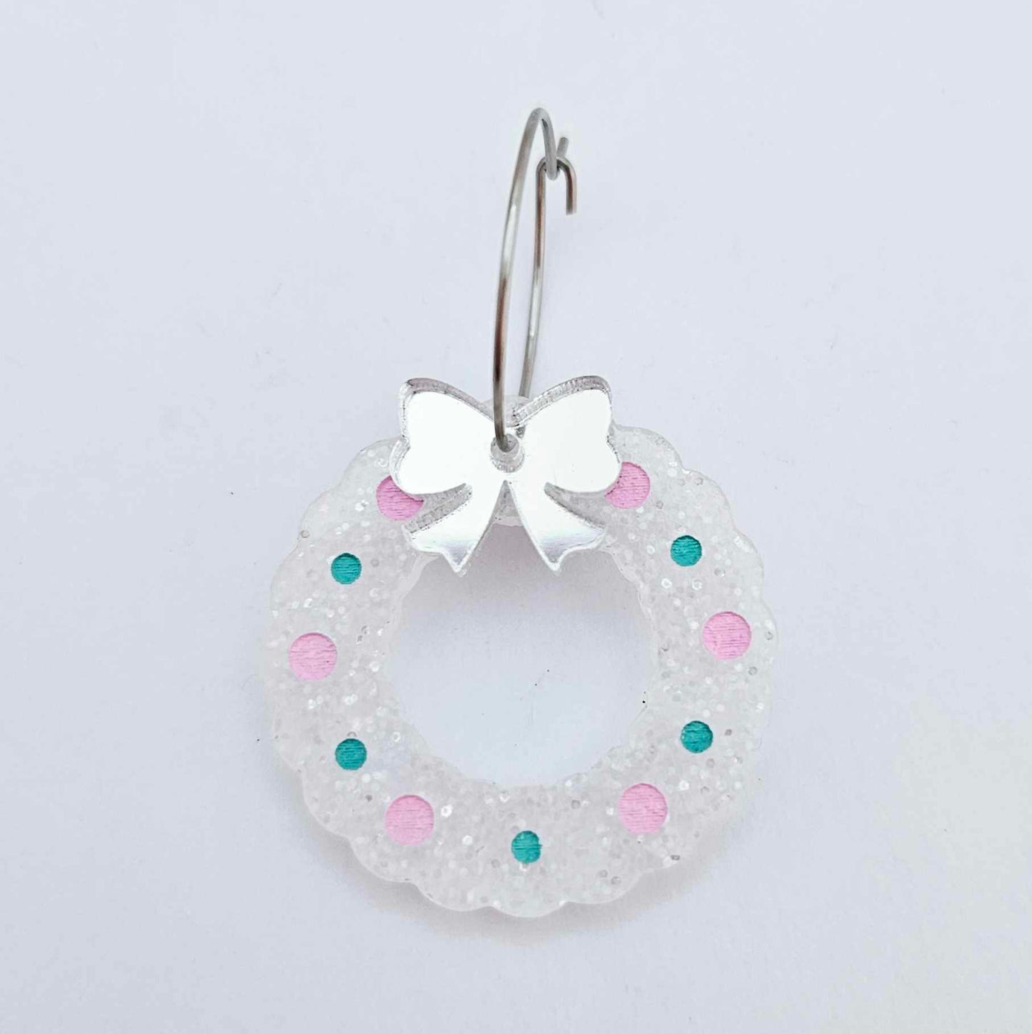 fairy dust glitter acrylic wreath earring blanks that have been paint filled with aqua green and lavender posca paint pens