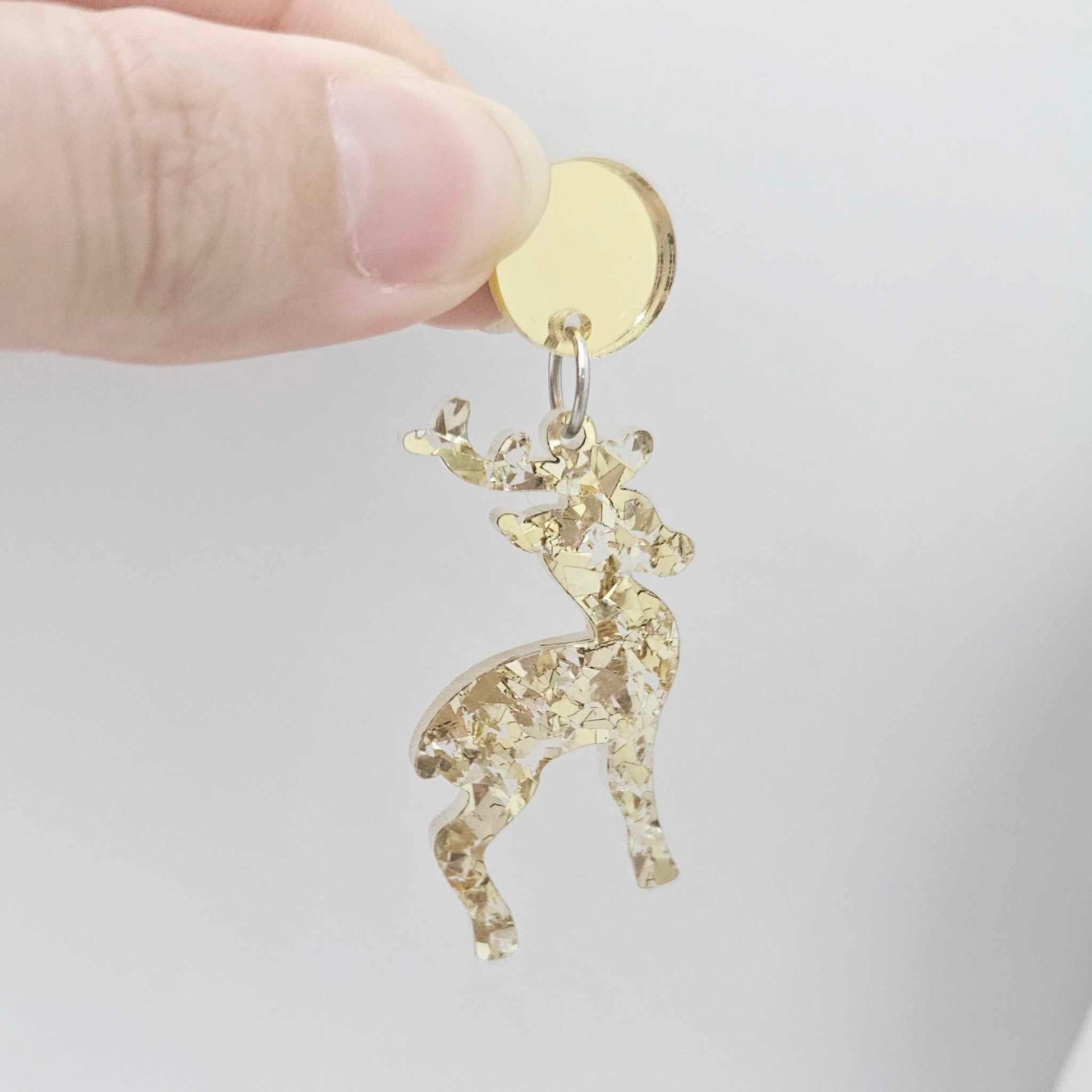 gold mirror earring toppers paired with Christmas reindeer dangles for festive earrings