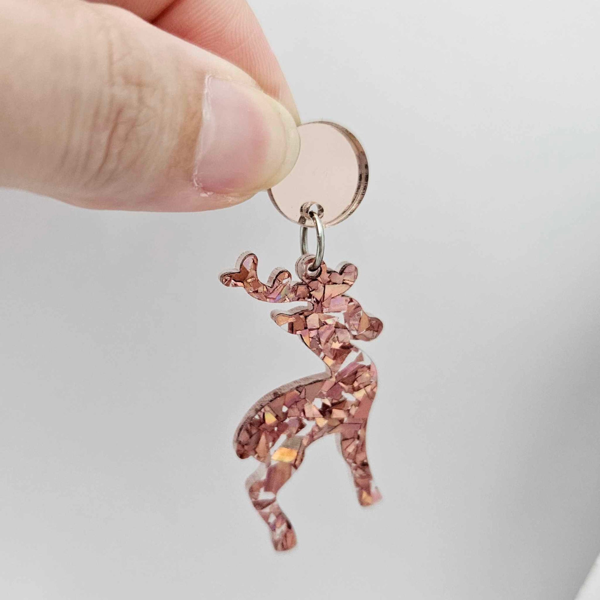 Rose gold mirror earring toppers paired with Christmas reindeer dangles for festive earrings