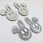 38mm silver glitter acrylic bunny dangle blanks with engraved smiley face, two paint filled white and two others unfilled with protective film on