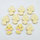 Pastel yellow acrylic chicken head stud blanks showing two paint filled examples and several unpainted 