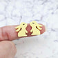 Close-up of pastel yellow acrylic bunny stud blanks with paint filled eyelashes