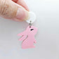 32mm Pastel pink bunny dangle blanks showing paint filled black eyelashes on two pieces, with remaining pieces shown with protective paper as supplied