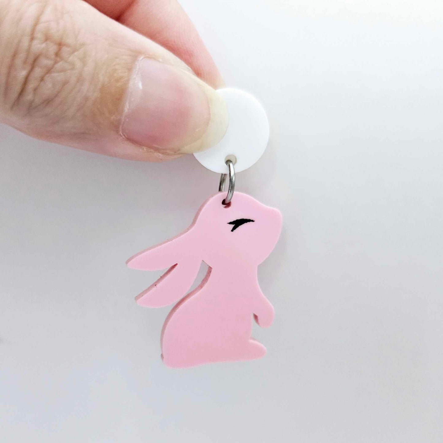 32mm Pastel pink bunny dangle blanks showing paint filled black eyelashes on two pieces, with remaining pieces shown with protective paper as supplied