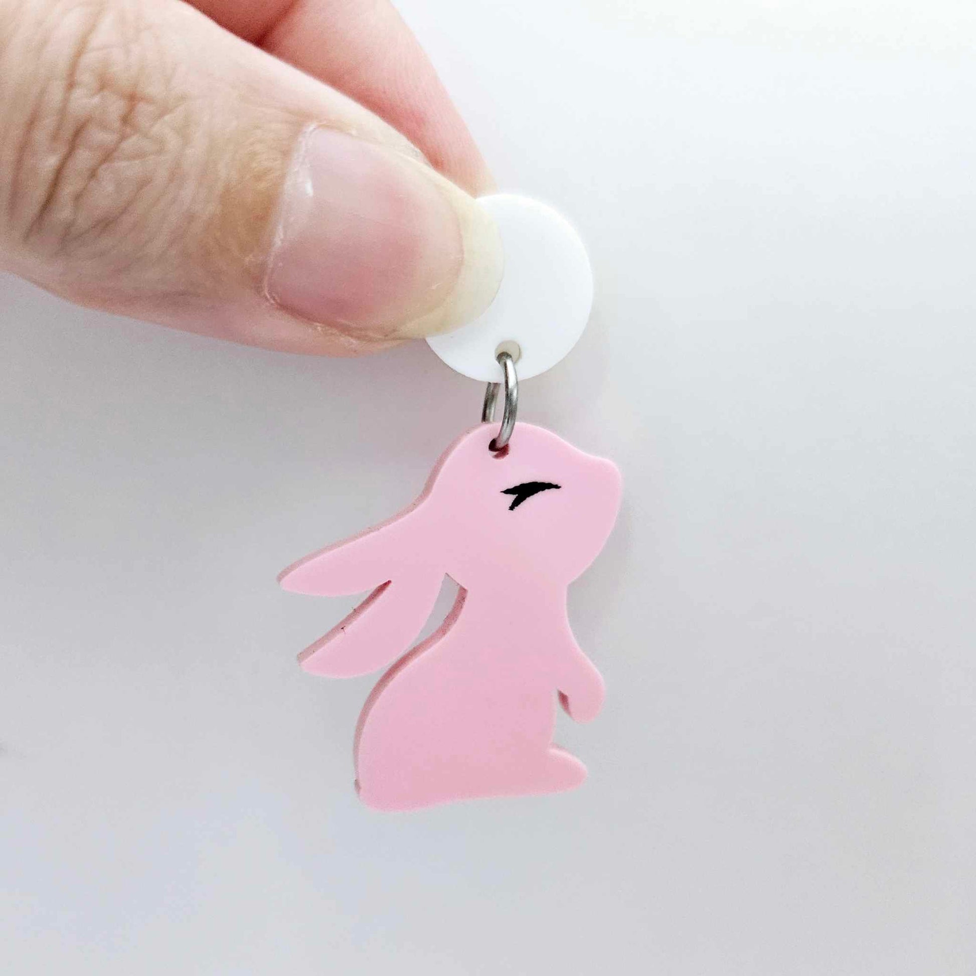 32mm Pastel pink bunny dangle blanks showing paint filled black eyelashes on two pieces, with remaining pieces shown with protective paper as supplied