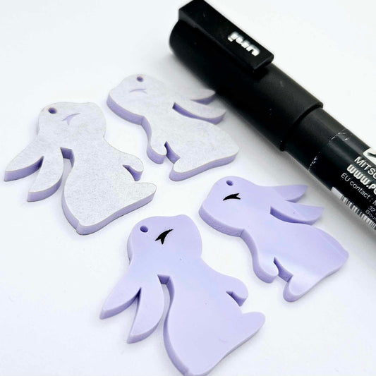 32mm pastel purple bunny dangle blanks showing paint filled black eyelashes on two pieces, with remaining pieces shown with protective paper as supplied