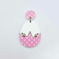Assembled cracked egg dangle earring blank with white top and pastel pink polka dot UV printed bottom, hanging from a 14mm pink polka dot earring topper