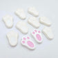 white bunny paw print stud blanks showing two paint filled pink and several unpainted pieces
