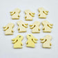 Pastel yellow bunny stud blanks showing finished paint filled black eyelashes on two studs, with the rest shown as supplied with protective film