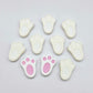 white bunny paw print stud blanks showing two paint filled pink and several unpainted pieces