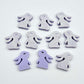 Pastel purple bunny stud blanks showing finished paint filled black eyelashes on two studs, with the rest shown as supplied with protective film