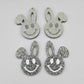 38mm silver glitter acrylic bunny dangle blanks with engraved smiley face, two paint filled white and two others unfilled with protective film on