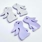 32mm pastel purple bunny dangle blanks showing paint filled black eyelashes on two pieces, with remaining pieces shown with protective paper as supplied