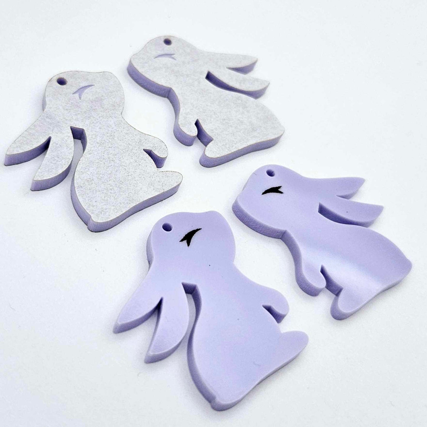 32mm pastel purple bunny dangle blanks showing paint filled black eyelashes on two pieces, with remaining pieces shown with protective paper as supplied