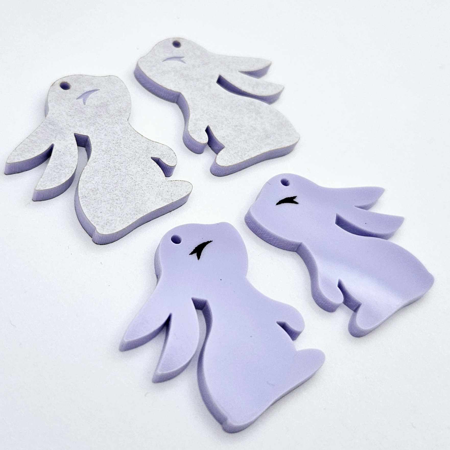 32mm pastel purple bunny dangle blanks showing paint filled black eyelashes on two pieces, with remaining pieces shown with protective paper as supplied