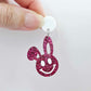 Hot pink glitter acrylic bunny dangle earring blank hanging from a 14mm white acrylic topper, bunny head with floppy ear and paint filled smiley face