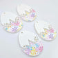 Four cracked egg earring blanks unassembled, white top halves and pastel pop UV printed bottom halves