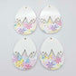 Four cracked egg earring blanks unassembled, white top halves and pastel pop UV printed bottom halves