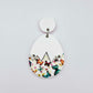 Assembled cracked egg acrylic dangle earring blank with white top and butterfly UV printed bottom, hanging from a 14mm white earring topper