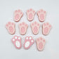 Pastel pink bunny paw print stud blanks showing two paint filled white and several unpainted pieces