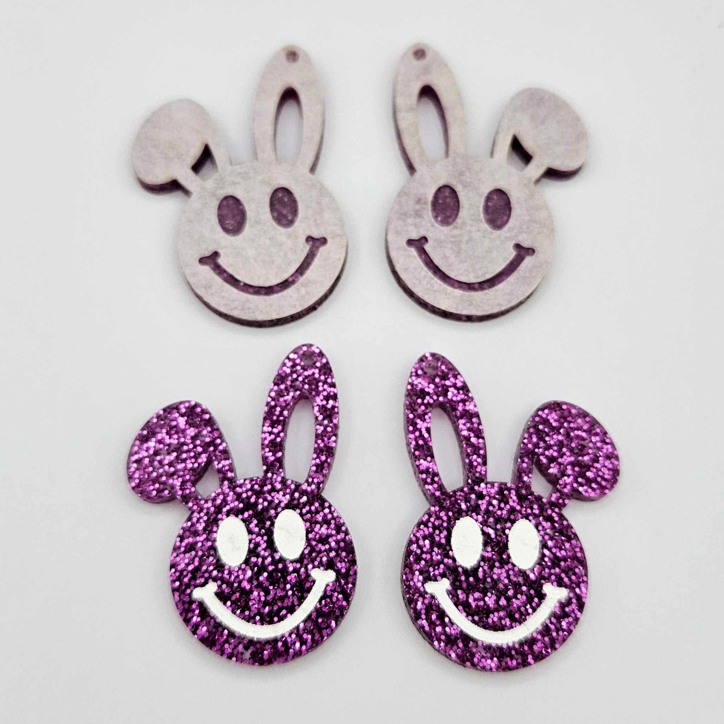38mm purple glitter acrylic bunny dangle blanks with engraved smiley face, two paint filled white and two others unfilled with protective film on