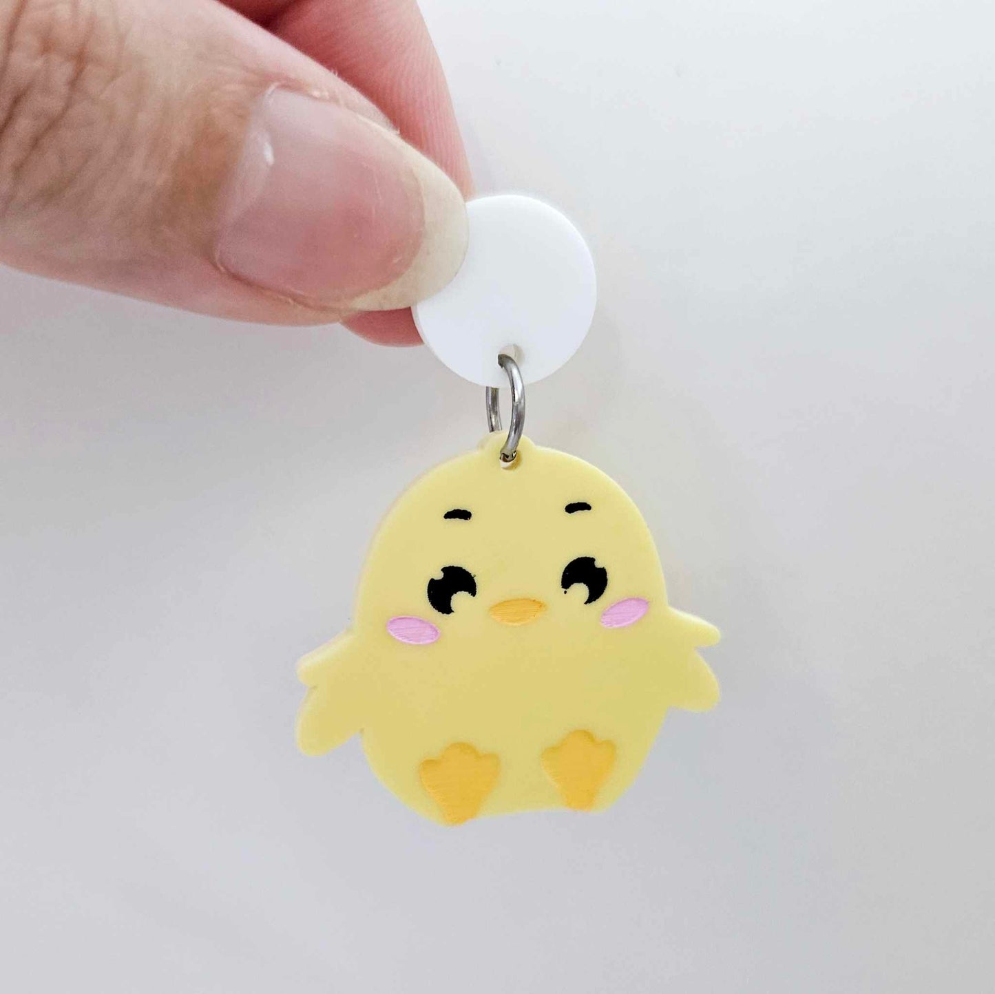 Pastel yellow acrylic chicken dangle hanging from a 14mm white acrylic topper, engraved chicken face with rosy cheeks paint filled