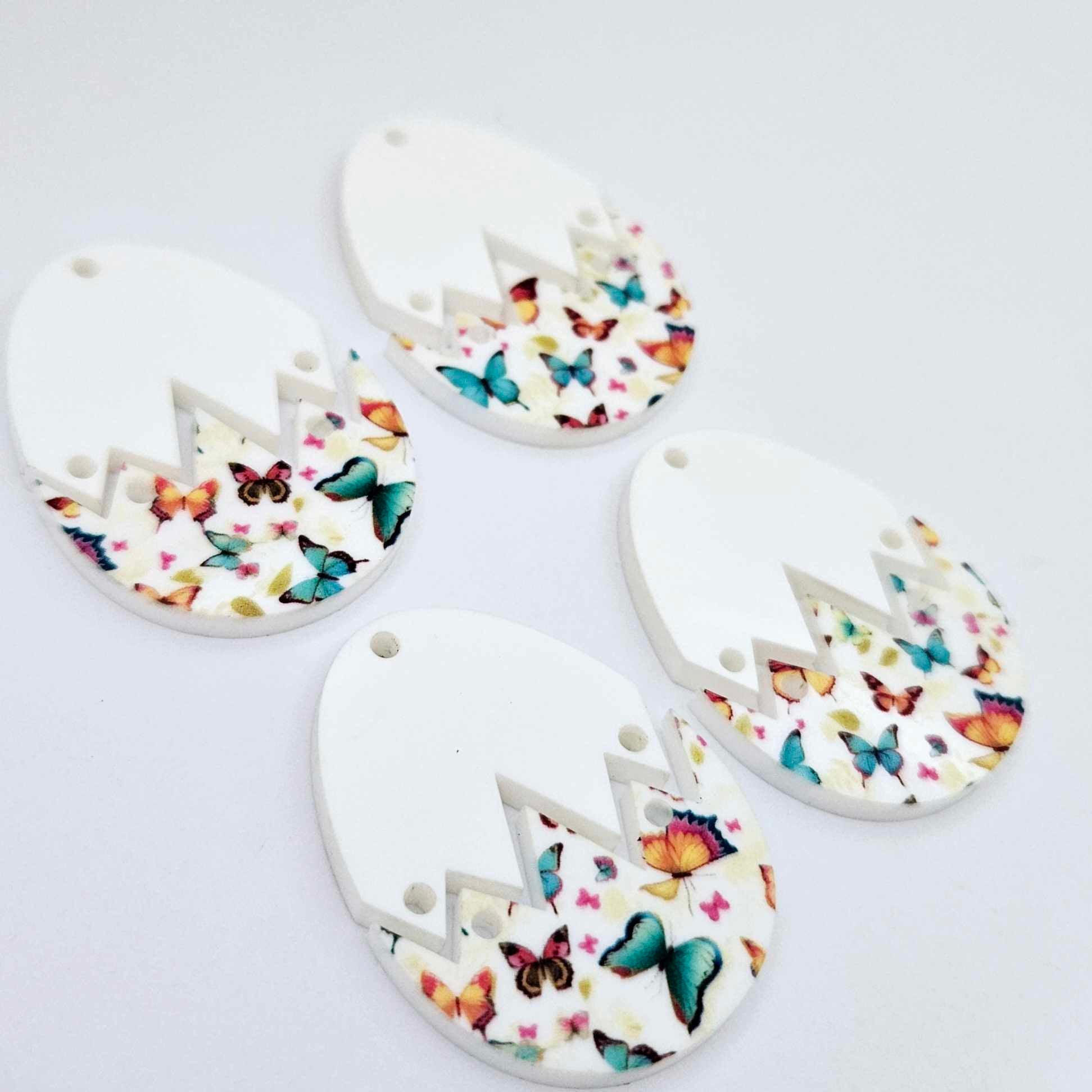 Four cracked egg acrylic Easter earring blanks unassembled, white top halves and butterfly UV printed bottom halves