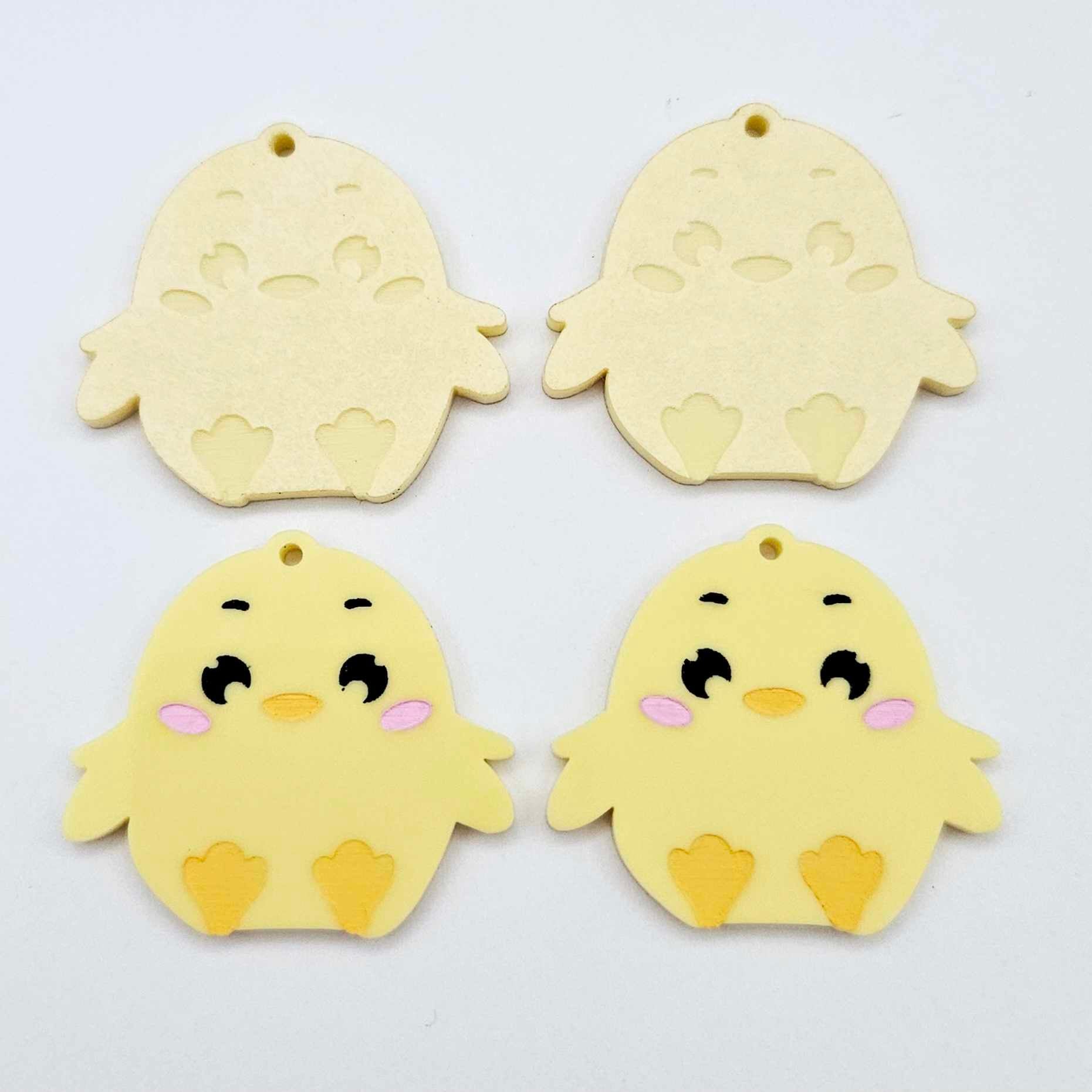 Pastel yellow acrylic chicken dangle blanks with engraved face and feet, two paint filled and two with protective film on