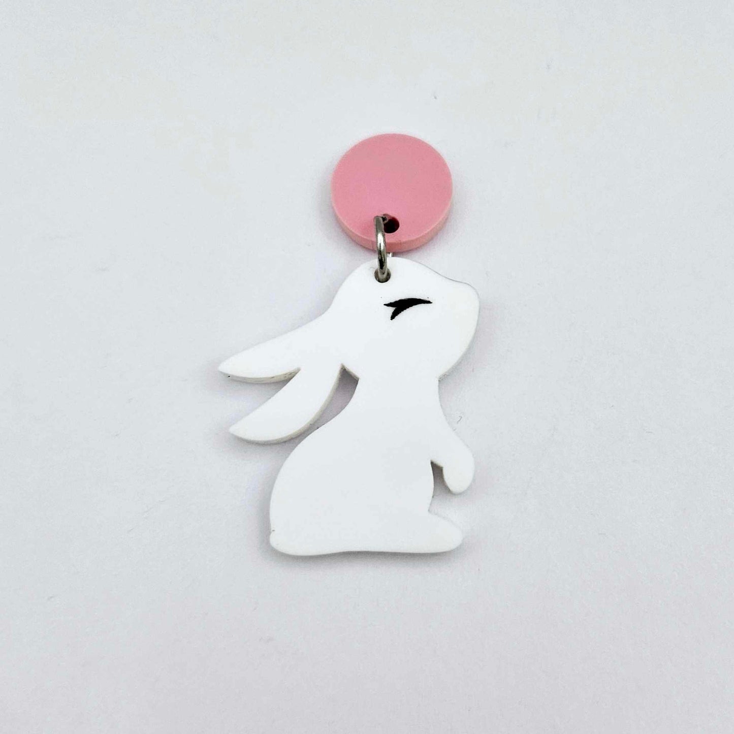 32mm white bunny dangle blanks showing paint filled black eyelashes hanging from a pastel pink topper