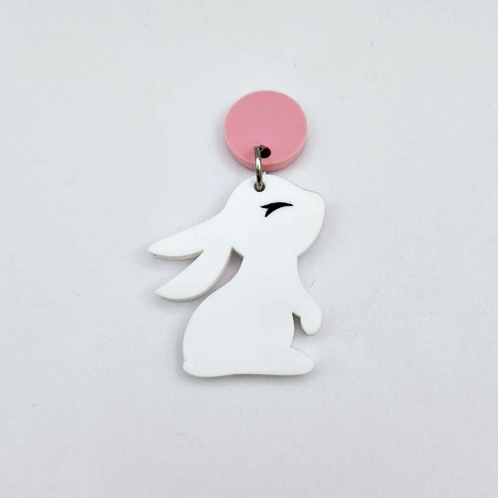 32mm white bunny dangle blanks showing paint filled black eyelashes hanging from a pastel pink topper