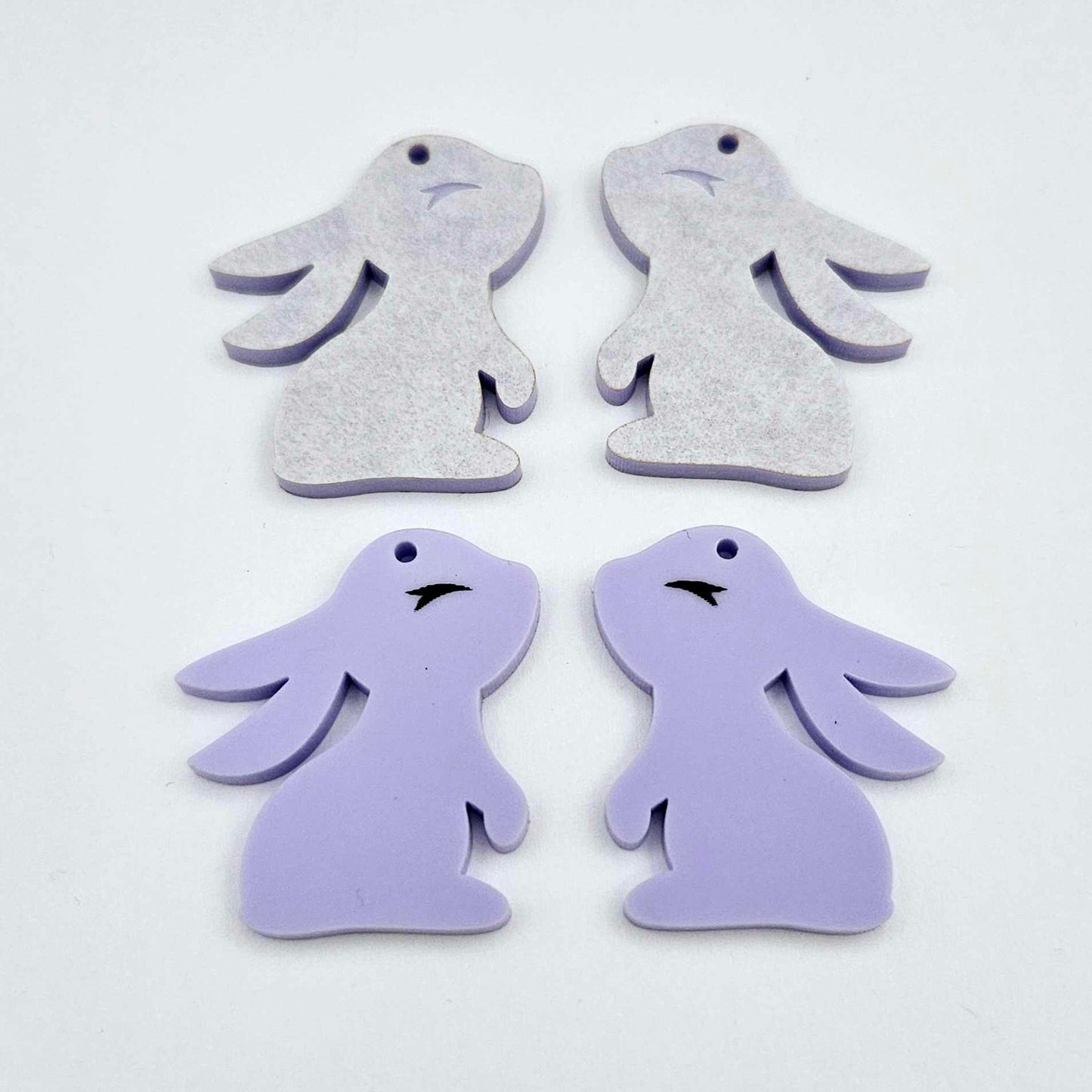 32mm pastel purple bunny dangle blanks showing paint filled black eyelashes on two pieces, with remaining pieces shown with protective paper as supplied