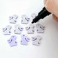 Pastel purple bunny stud blanks showing finished paint filled black eyelashes on two studs, with the rest shown as supplied with protective film
