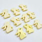 Pastel yellow bunny stud blanks showing finished paint filled black eyelashes on two studs, with the rest shown as supplied with protective film