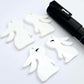 32mm white bunny dangle blanks showing paint filled black eyelashes on two pieces, with remaining pieces shown with protective paper as supplied