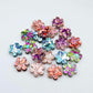 10mm chunky glitter flower stud blanks in mixed colours, shown as a pile of assorted mini acrylic flowers