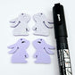 32mm pastel purple bunny dangle blanks showing paint filled black eyelashes on two pieces, with remaining pieces shown with protective paper as supplied