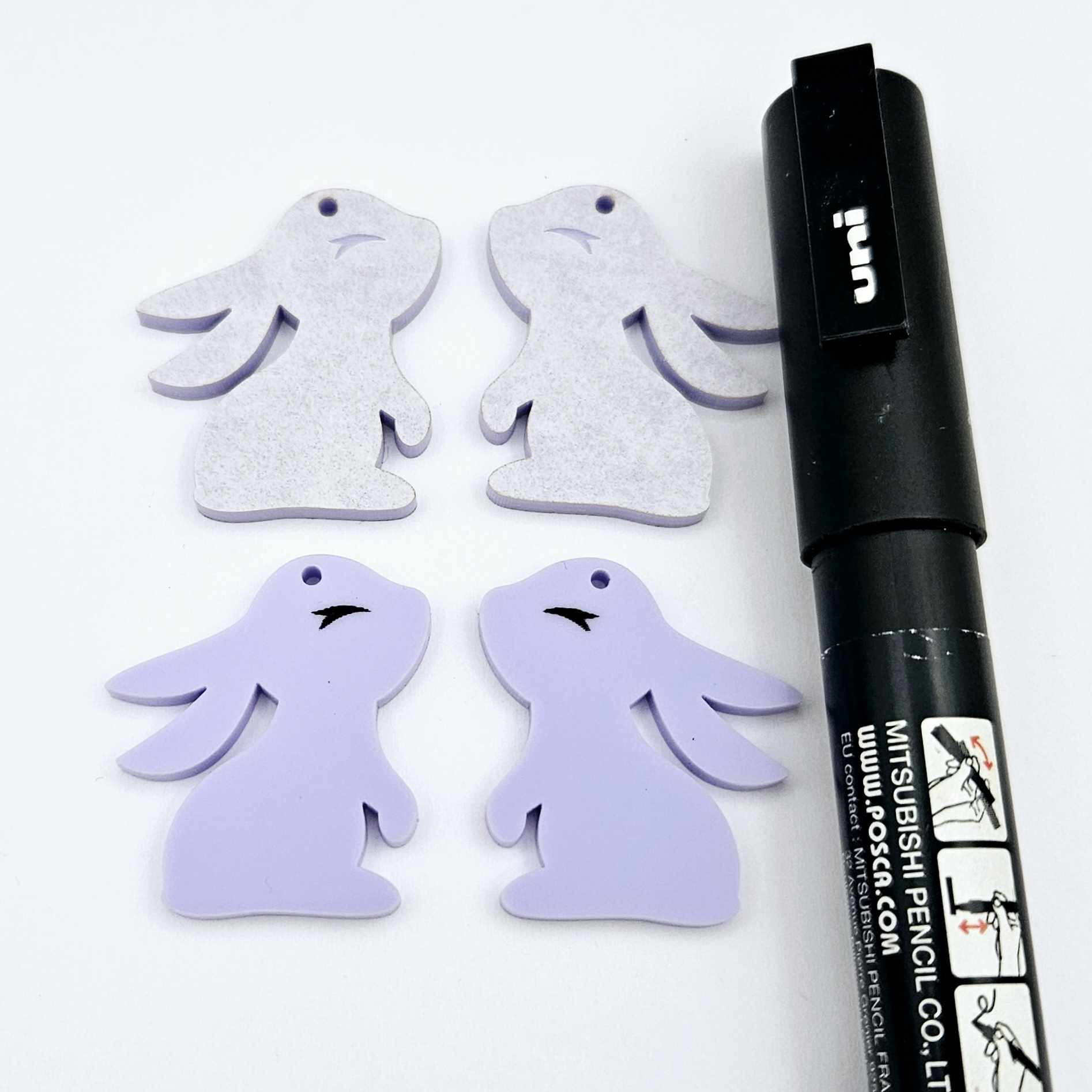 32mm pastel purple bunny dangle blanks showing paint filled black eyelashes on two pieces, with remaining pieces shown with protective paper as supplied