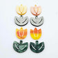 Two-piece tulip acrylic dangle blanks in orange artist swirl and green mineral acrylic, paint filled white on one pair with remaining pair unfilled