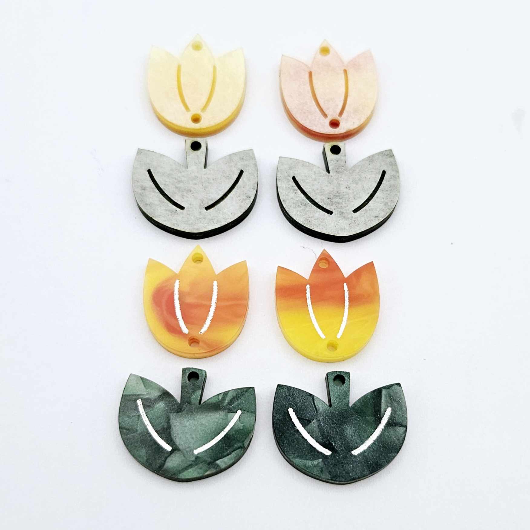 Two-piece tulip acrylic dangle blanks in orange artist swirl and green mineral acrylic, paint filled white on one pair with remaining pair unfilled