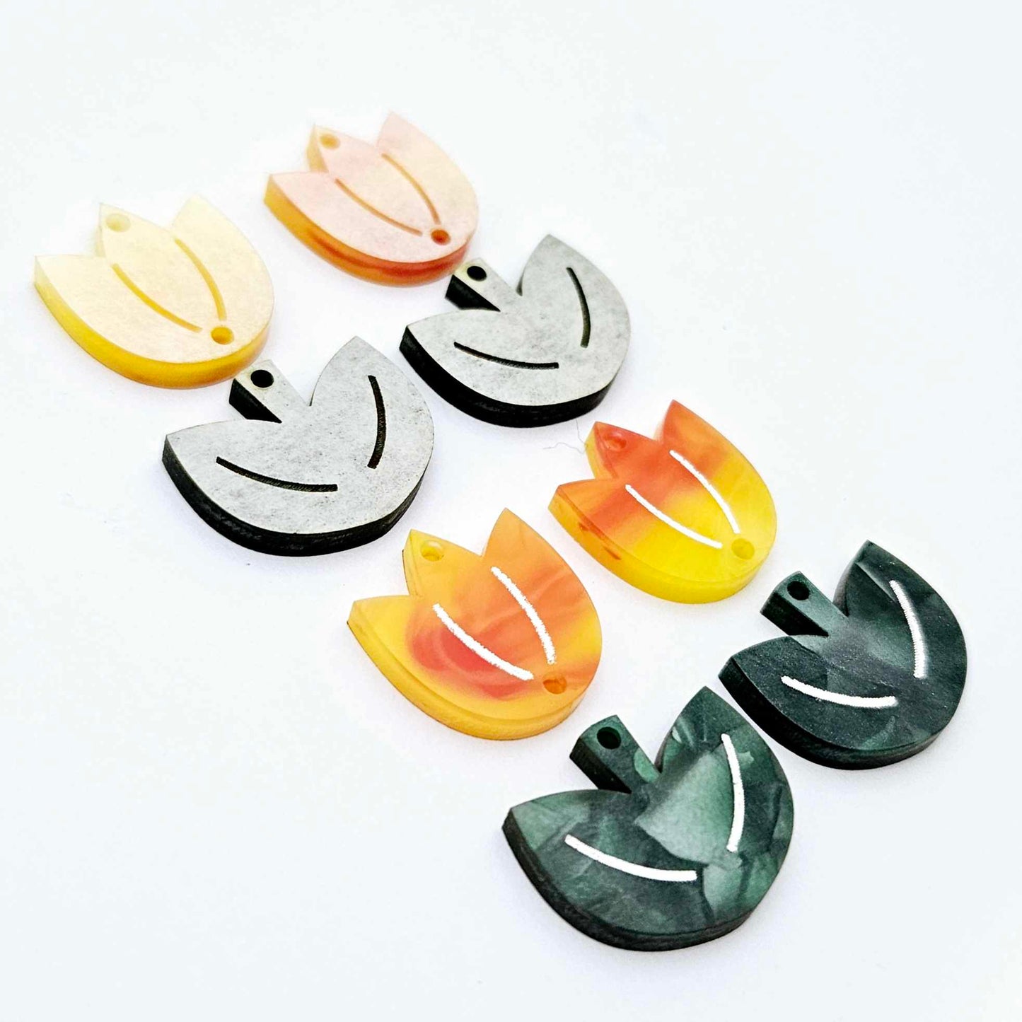 Two-piece tulip acrylic dangle blanks in orange artist swirl and green mineral acrylic, paint filled white on one pair with remaining pair unfilled