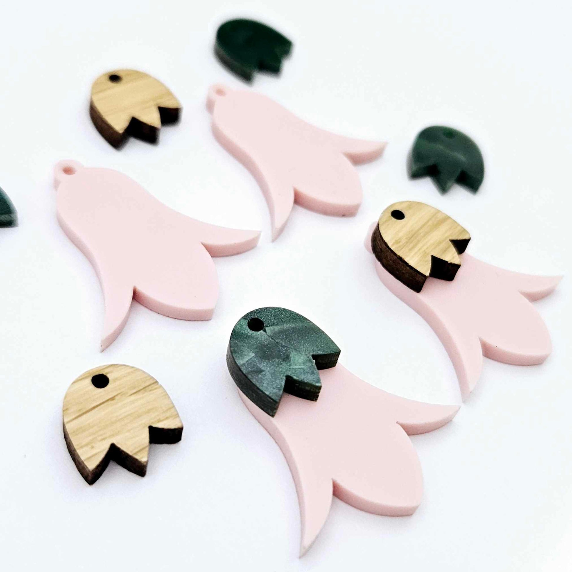 28mm dusty pale pink nodding flower dangle blanks shown on their own and with oak wood and green mineral leaf cap pieces